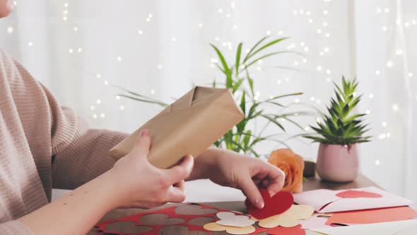 Female Artist Designer is Decorating a Gift Box