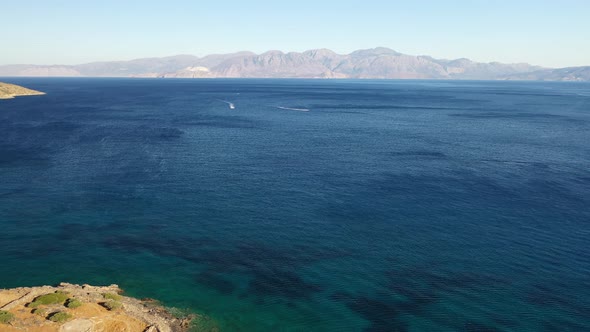 Aerial View of a Jet Ski Boat in a Deep Blue Colored Sea. Spinalonga Island, Crete, Greece