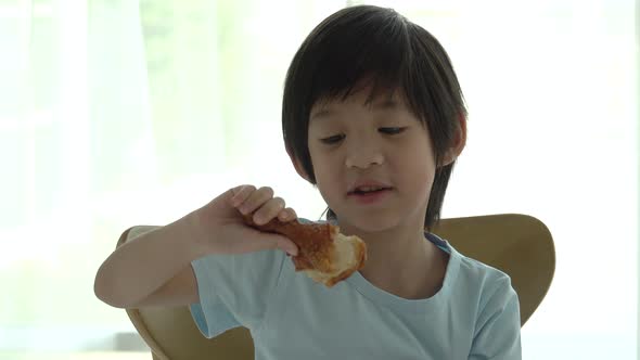 Cute Asian Child Eating Fried Chicken