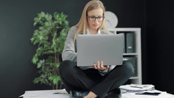 Woman with Laptop on Desk