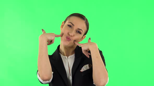 Trendy Girl Poses for Camera Makes Funny Faces. Green Screen