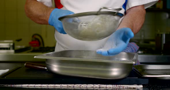 Cook Is Breading Onion in Flour at Kitchen of Restaurant, Professional Chef, Detail of Hands