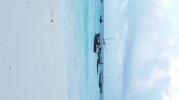 Vertical Video Boats in the Ocean Near the Coast of Zanzibar Tanzania Aerial View