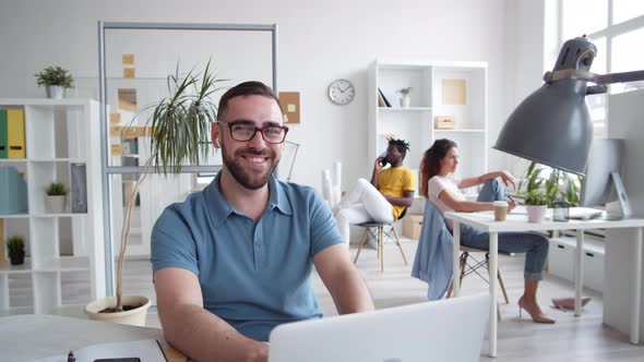 Casual Bearded Businessman Looking at Camera