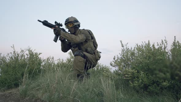 Sniper in Military Equipment Quickly Runs Out From Behind Bushes Takes Aim at Eyepiece of Sniper