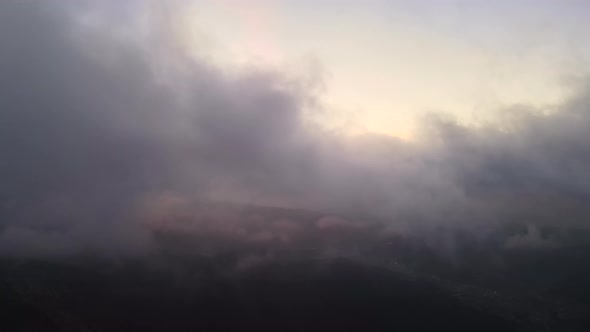 Aerial View of Bright Foggy Morning Over Dark Peak with Mountain Forest Trees at Autumn Sunrise