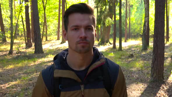 A Hiker Walks Down a Path Through a Forest - Closeup