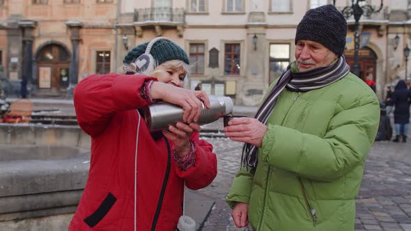 Senior Couple Tourists Grandmother Grandfather Drinking From Thermos Enjoying Hot Drink Tea Coffee