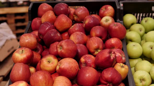 Closeup of a Lot of Red Apples in a Box on a Shelf in a Supermarket