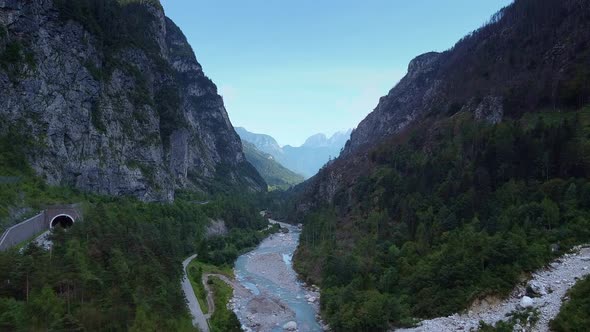 Aerial Drone Shot of a River in the Valley with High Mountains Around