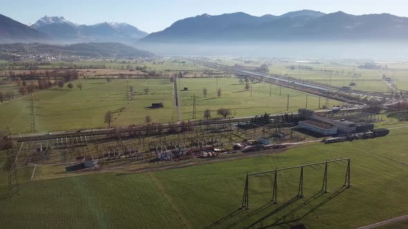 Aerial drone of energy farm company in Uznach during sunny day in mountains.