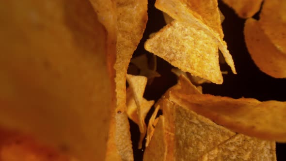 Super Slow Motion Shot of Flying Tortilla Chips Towards the Camera on Black Background at 1000Fps