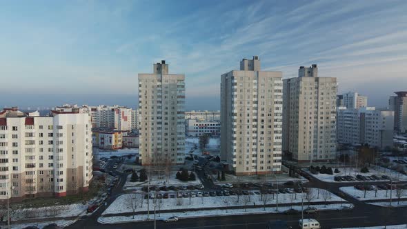 Flight over the city block. Modern multi-storey buildings.