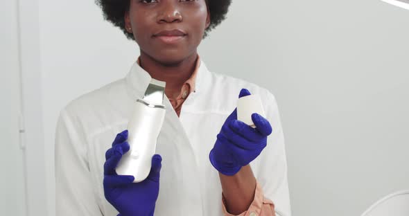 Portrait of a Female African American Cosmetologist Doctor Holding in Her Hands