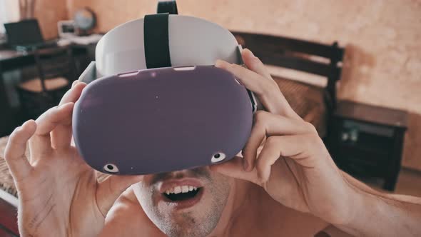 Young Man With a Naked Torso for the First Time in Virtual Reality Glasses