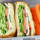 Fresh made sandwiches with carrot sticks in the lunch box, ready to eat, dolly shot, top view - VideoHive Item for Sale