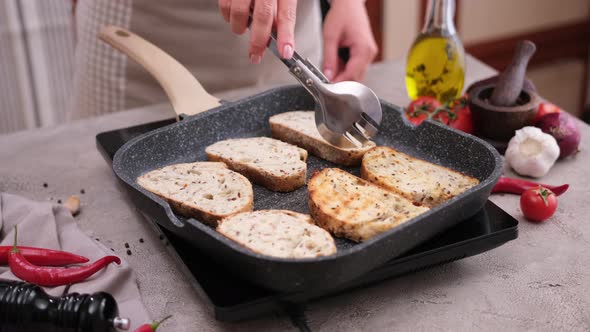 Toasting Slices of Baguette in a Grill Frying Pan