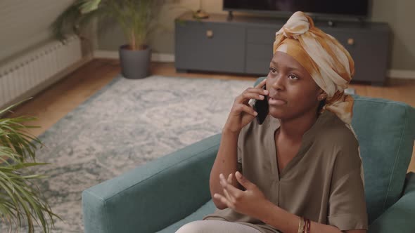 Cheerful Black Woman Talking on Cellphone Indoors