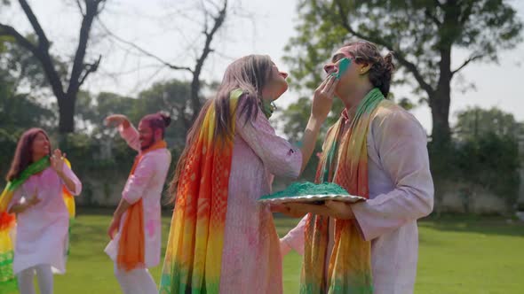 Romantic Indian couple playing Holi