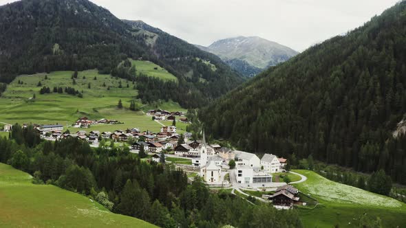 Panoramic View of a Picturesque Mountain Valley with a Village in a Lowland