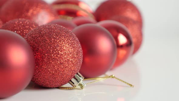 Christmas holiday decoration  baubles on golden strings slow tilt 4K footage