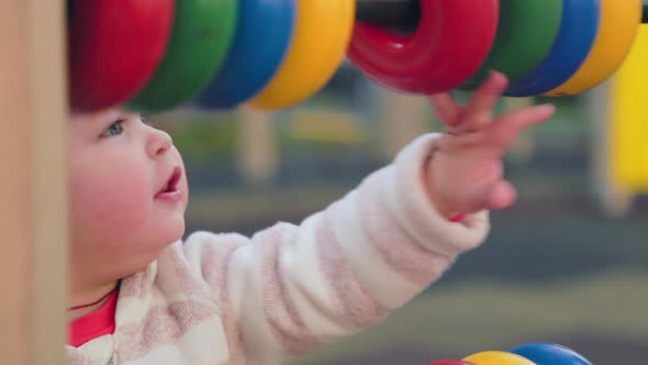 Close up portrait of cute little girl is playing educational games on the playground.