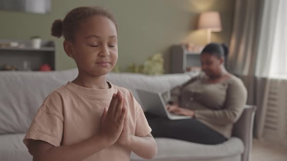 African-American Girl Practicing Yoga at Home