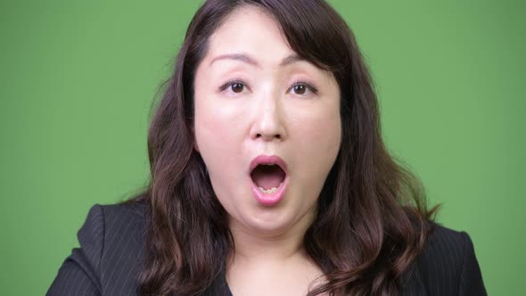 Mature Beautiful Asian Businesswoman Looking Shocked