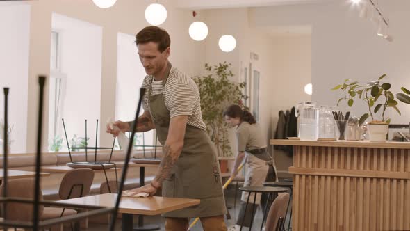 Workers Cleaning in Cafe Before Opening