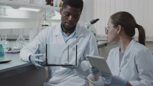 Scientists Observing Lab Rat and Making Notes