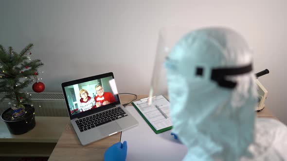 Male Doctor in the Laboratory Uses a Laptop Gadget for a Video Call with His Parents