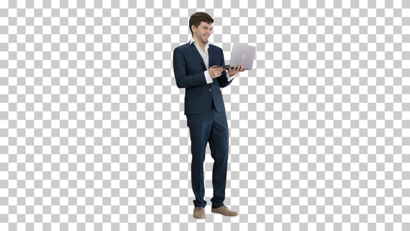 Smiling young businessman using laptop, Alpha Channel