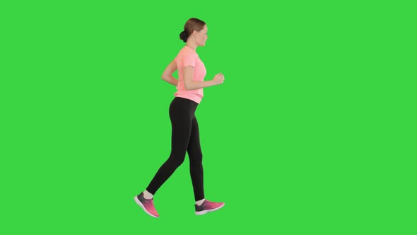 Woman in a Pink Tshirt Running on a Green Screen Chroma Key