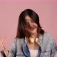 Happy pretty Asian teenager girl dancing and flicking hair on pink background, Slow motion shot. - VideoHive Item for Sale