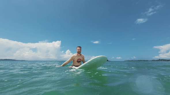 Guy Surfs on Waves in Ocean Closeup