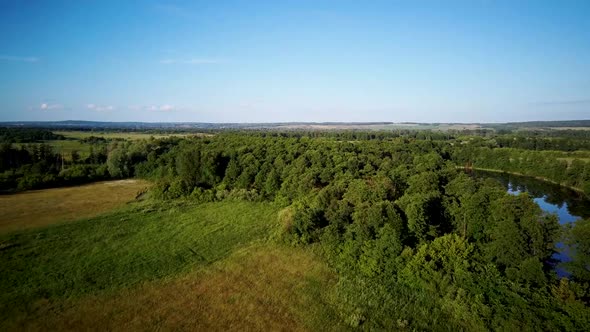 Aerial Video of the Lake on a Warm Summer Day in Light of the Setting Sun