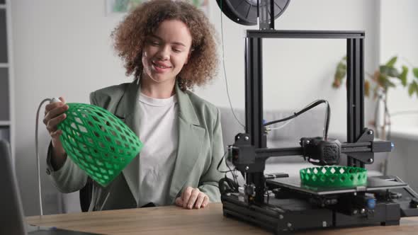 Happy Woman with Prototype of Shade for Lamp in Hands Made on 3D Printer Using Modern Technologies