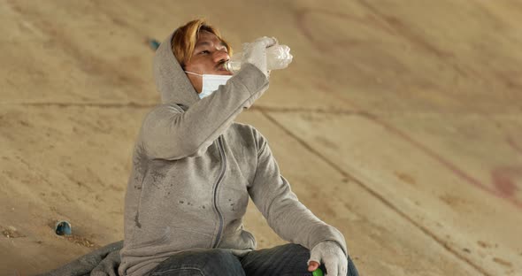 Homeless man drinking water