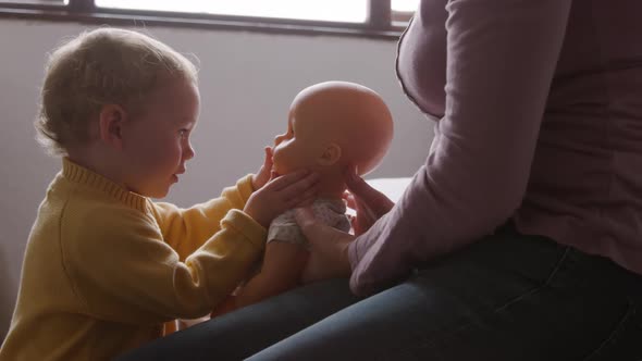 Side view of baby playing at home