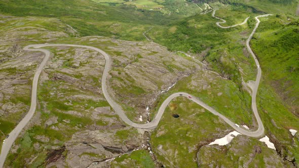 Aerial View Of Cars Driving Slowly On Winding Road By The Mountains In Norway From Eidsdal To Geiran