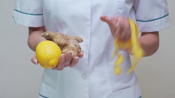 Nutritionist Doctor Healthy Lifestyle Concept - Holding Ginger Root, Lemon Fruit and Measuring Tape