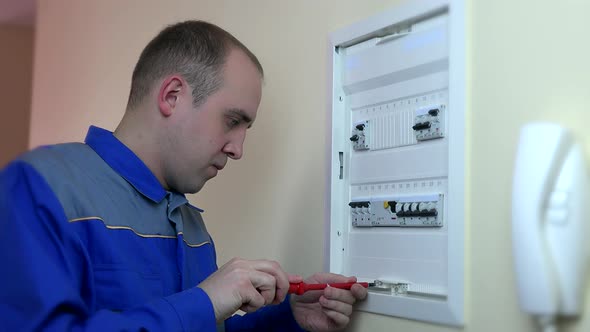 Closeup Of Experienced Electrician Repairing Circuit Breaker