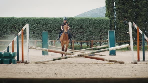 Kid on horse jumping over barrier.