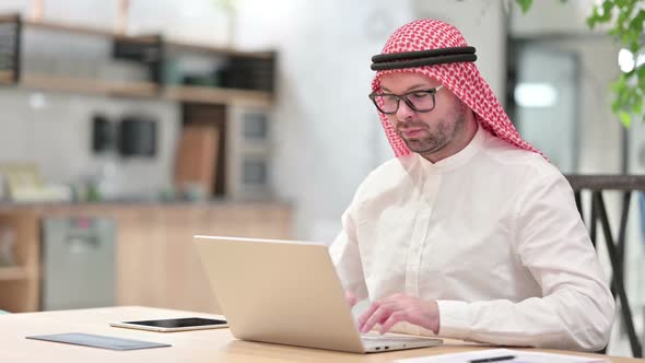 Thumbs Up By Positive Young Arab Businessman Working in Office