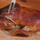 Delicious Young Roasted Duck Is Cut Off Along Leg With Sharp Knife - VideoHive Item for Sale