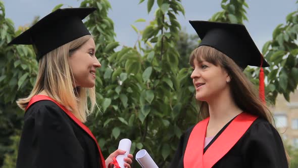 Beautiful Females Graduates Discussing Future Plans After Receiving Diplomas