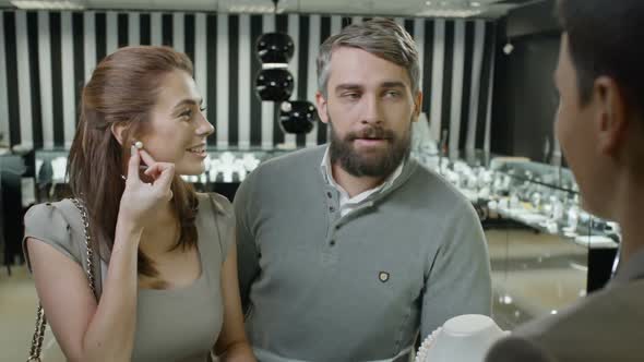 Husband and Wife Choosing Earring in Jewelry Store