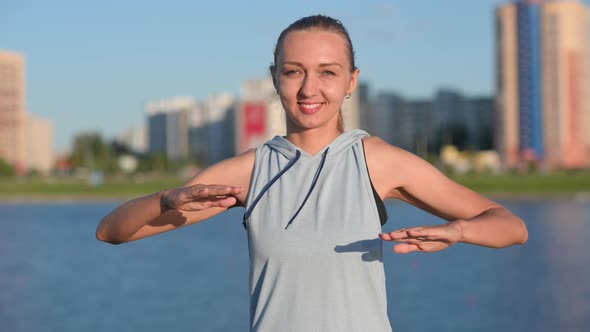 Young fit girl in sportswear is working out outdoors.