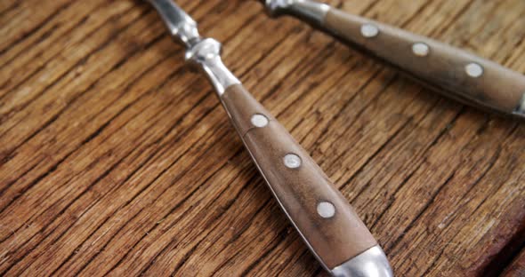 Various cutlery on wooden table 4k