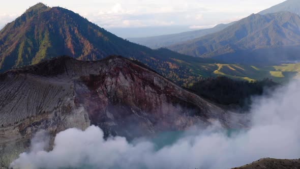 Crater of Ijen volcano, Java, Indonesia. Landscape with the green lake and the smoke